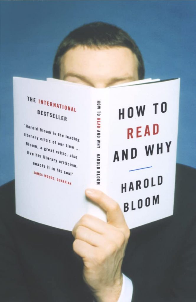 Man holding book up to face